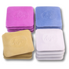 A collection of four stacks of tailor's chalk in various colors including pink, blue, beige, and white, each stack is labeled with a number.